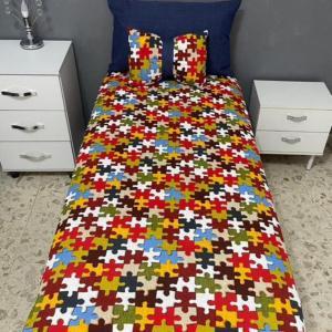 Lenzuolo + 2 cuscini fantasia puzzle